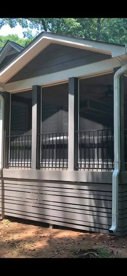 Screened porch with glass panels, black aluminum frames, and composite siding