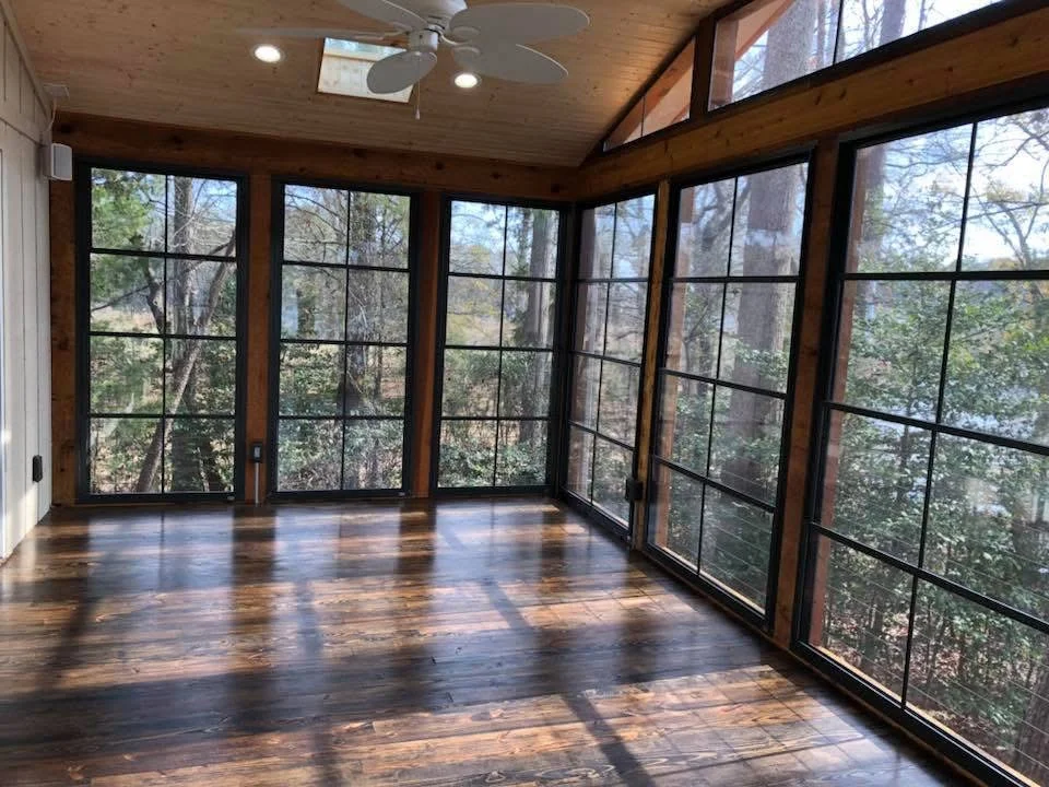 Sunroom with wood beams, recessed lights, multi-pane windows, and stained hardwood flooring